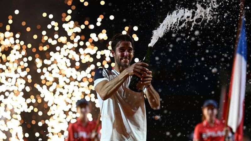 Argentina's Tomas Etcheverry celebrates with champagne after defeating Chile's Alejandro Tabilo during their men's singles final match at the Rio Open tennis tournament in Rio de Janeiro, Brazil, on February 22, 2026. 
MAURO PIMENTEL / AFP
