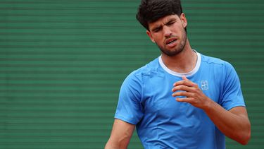 Spain's Carlos Alcaraz reacts as he plays against Italy's Jannik Sinner during the Monte Carlo ATP Masters Series Tournament final tennis match on Court Rainier III at the Monte-Carlo Country Club in Roquebrune-Cap-Martin, south-eastern France on April 12, 2026. 
Valery HACHE / AFP