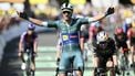 Lidl - Trek team's Italian rider Jonathan Milan wearing the best sprinter's green jersey cycles to the finish line to win ahead of Team Visma - Lease a bike team's Belgian rider Wout van Aert (R) placing second after the 8th stage of the 112th edition of the Tour de France cycling race, 171.4 km between Saint-Meen-le-Grand and Laval Espace Mayenne, western France, on July 12, 2025. 
Marco BERTORELLO / AFP