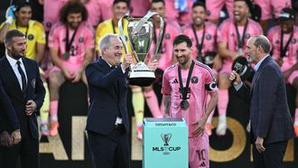 Inter Miami's managing owner Jorge Mas (C-L) lifts the trophy next to Argentine forward Lionel Messi (C-R) after winning the Major League Soccer (MLS) Cup final between Inter Miami and the Vancouver Whitecaps at Chase Stadium in Fort Lauderdale, Florida, on December 6, 2025. 
CHANDAN KHANNA / AFP