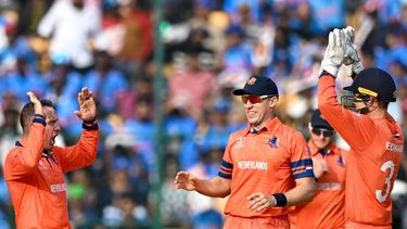 Netherlands' Roelof van der Merwe (L) celebrates with teammates after taking the wicket of India's Virat Kohli during the 2023 ICC Men's Cricket World Cup one-day international (ODI) match between India and Netherlands at the M. Chinnaswamy Stadium in Bengaluru on November 12, 2023. 
R.Satish BABU / AFP