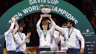Italy's Jannik Sinner raises the trophy with teammates after winning the Davis Cup Finals at the Palacio de Deportes Jose Maria Martin Carpena arena in Malaga, southern Spain, on November 24, 2024. 
Thomas COEX / AFP