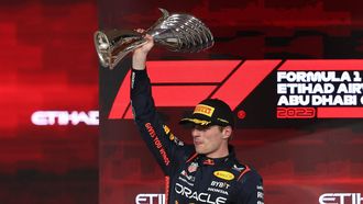 2023-11-26 18:49:47 epa10996345 Dutch Formula One driver Max Verstappen of Red Bull Racing celebrates on the podium with his trophy after winning the Formula 1 Abu Dhabi Grand Prix in Abu Dhabi, United Arab Emirates, 26 November 2023.  EPA/ALI HAIDER