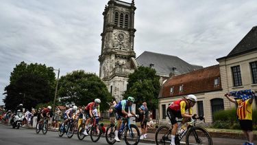 Cofidis team's French rider Benjamin Thomas (R) leads a breakaway past the Eglise catholique Saint-Martin church in Carvin, during the 1st stage of the 112th edition of the Tour de France cycling race, 184.9 km starting and finishing in Lille Metropole, northern France, on July 5, 2025. 
Marco BERTORELLO / AFP
