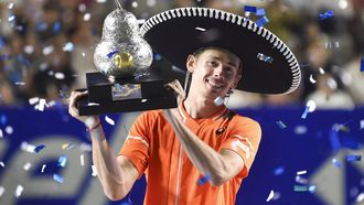 Australia's Alex De Minaur celebrates with his trophy after winning the Mexico ATP Open 500 men's singles final tennis match against Norway's Casper Ruud at the Arena GNP Seguros in Acapulco, Guerrero State, Mexico on March 2, 2024. 
Rodrigo Oropeza / AFP