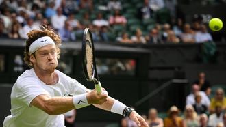 2023-07-09 17:10:36 Russia's Andrey Rublev returns the ball to Kazakhstan's Alexander Bublik during their men's singles tennis match on the seventh day of the 2023 Wimbledon Championships at The All England Tennis Club in Wimbledon, southwest London, on July 9, 2023.  
Daniel LEAL / AFP