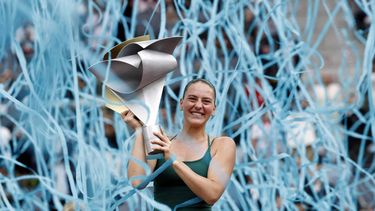 Ukraine's Marta Kostyuk celebrates on the podium with her trophy after beating Russia's Mirra Andreeva during the 2026 WTA Tour Madrid Open tennis tournament final singles match at the Caja Magica in Madrid, on May 2, 2026. 
Oscar DEL POZO / AFP