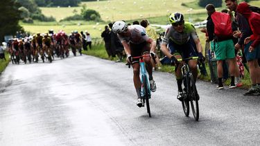 AG2R Citroen Team's French rider Dorian Godon (C) and Intermarche - Circus - Wanty's Belgian rider Rune Herregodts (R) compete in the breakaway during the first stage of the 75th edition of the Criterium du Dauphine cycling race, some 158kms between Chambon-sur-Lac to Chambon-sur-Lac, central France, on June 4, 2023. 
Anne-Christine POUJOULAT / AFP