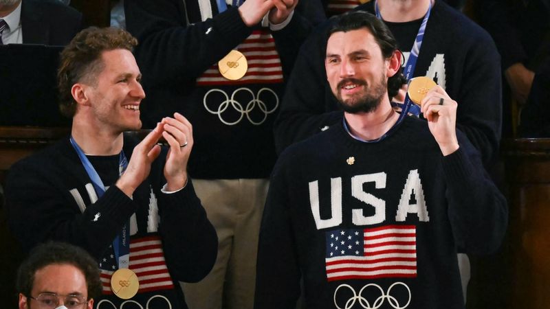 Goalie Connor Hellebuyck raises his gold medal as members of the US Men's Olympic hockey team are recogized by US President Donald Trump as he delivers the State of the Union address in the House Chamber of the US Capitol in Washington, DC, on February 24, 2026. 
ANDREW CABALLERO-REYNOLDS / AFP