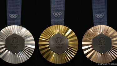 (COMBO) This combination of pictures created on January 30, 2024 in Paris shows the upcoming Paris 2024 Olympics medals designed by Fench luxury jewellery house Chaumet. On the medals' head side, the engraved figures of the goddess of victory Athena, Nike, the Panathenaic stadium and the Acropolis are imposed by the International Olympic Committee (IOC) but Paris 2024 has obtained exceptional authorization to add the design of the Eiffel Tower, and use 18 grams of Eiffel Tower metal on each medal, extracted from pieces of the tower.
Thomas SAMSON / AFP