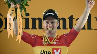 Uno-X Mobility team's Norwegian rider Jonas Abrahamsen celebrates on the podium after winning the 11th stage of the 112th edition of the Tour de France cycling race, 156.8 km starting and finishing in Toulouse, southwestern France, on July 16, 2025. 
Loic VENANCE / AFP
