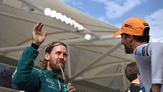 Aston Martin's German driver Sebastian Vettel (L) waves to the crowds as McLaren's Australian driver Daniel Ricciardo (R) looks on during driver's parage ahead of the Abu Dhabi Formula One Grand Prix at the Yas Marina Circuit in the Emirati city of Abu Dhabi on November 20, 2022. 
Ben Stansall / AFP
